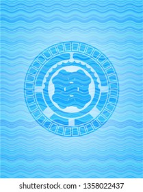 four leaf clover icon inside light blue water wave badge.