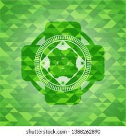 four leaf clover icon inside green emblem with mosaic ecological style background
