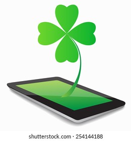 Four- leaf clover - Irish shamrock St Patrick's Day symbol. Useful for your design. Green glass clover  on white background.Stylish abstract St. Patrick's day  leaf clover whit tablet computer.