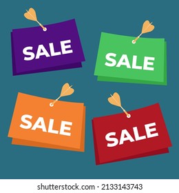 Four multicolored signs attached with a dart to the wall on a blue background, a sales concept for stores with the inscription SALE. Illustration of the sales concept.