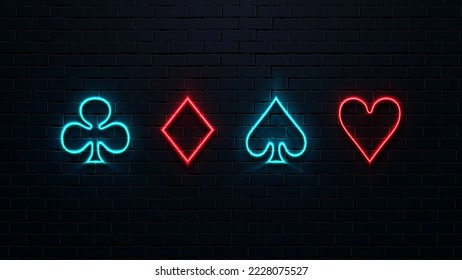 Four neon suits of cards on a brick wall background. Red and blue bright icons: diamonds, hearts, spades and crosses