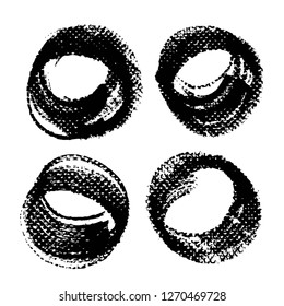 Four round abstract textured black strokes and stamps isolated on a white background
