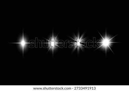 Four white lights with varying intensities and effects on a black background