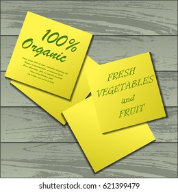 Four yellow stickers with sample text isolated on wooden background