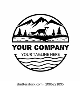 fox logo in a forest with a mountain above and a river below