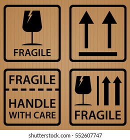Fragile shipping label symbol on brown cardboard texture background.