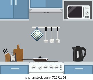 Fragment of kitchen interior in a blue color. There is a frying pan on the stove, a black kettle, a microwave and other objects in the picture. Vector flat illustration