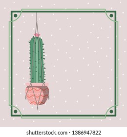 frame with cactus houseplant hanging in macrame