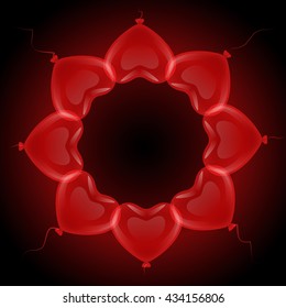 Frame circle of a variety of red gel balloons floating in a heart shape on a black background.