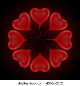Frame circle of a variety of red gel balloons floating in a heart shape on a black background.