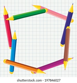 frame of colored pencils on notebook