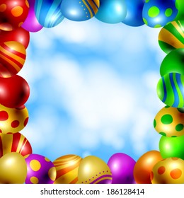 Frame of Easter eggs. Frame made of Easter eggs with various colors and patterns on blue sky with white fluffy clouds background.