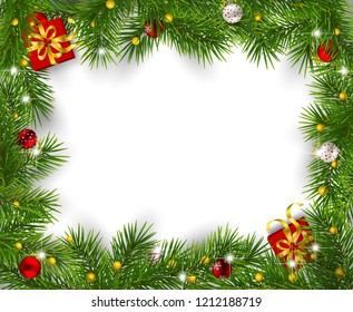 Frame of fir branches decorated with baubles  and gifts on white background. Christmas background with space for text.