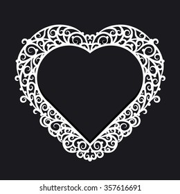 Frame heart with ornate trim on a black background. Design element for wedding or Valentine's Day.