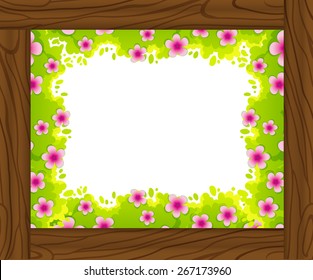 Frame of leaves and flowers on wooden background