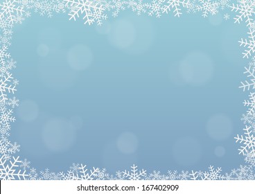 Frame made of snowflakes on light blue background with some bubbles in bokeh effect 