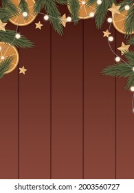 Frame made of spruce branches, oranges, garlands and star on a wooden background. 