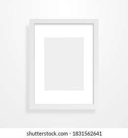 Frame mockup on light backdrop. Vertical empty picture. Realistic rectangle on a wall. Room interior object template. Clean photo blank with white border. Vector illustration.