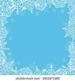 frame from white snowflakes of different sizes and transparency, framing, square shape on a blue background