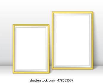 Frames near wall on the floor. Realistic vector golden photo frames ready for your design. Vector template for presentation your photo art, posters, paintings or other crafts.