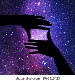 Framing hands. Hand gesture silhouette. Night starry sky and Milky Way