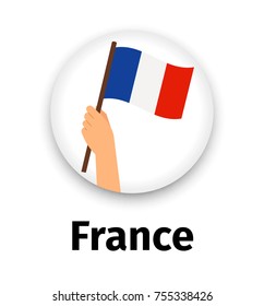 France flag in hand, round icon with shadow isolated on white. Human hand holding flag