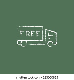Free delivery truck hand drawn in chalk on a blackboard vector white icon isolated on a green background.