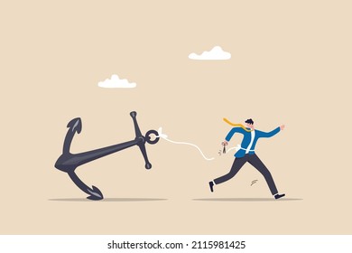Freedom, relief or escape from bad habit, psychology anchoring effect or cut heavy burden to growing more concept, businessman using scissor to cut the rope tie himself with big heavy anchor.