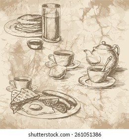 Freehand drawing of the breakfast on the old paper. Sausages, eggs, sunny side up, toast, crumpets, lemon, tea, juice and coffee with kettle. Vintage style of food design.