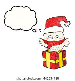 freehand drawn thought bubble textured cartoon cute christmas owl on wrapped present