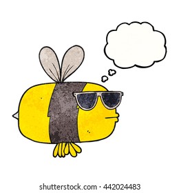 freehand drawn thought bubble textured cartoon bee wearing sunglasses