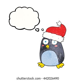 freehand drawn thought bubble textured cartoon penguin in christmas hat