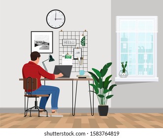 A freelancer man works behind a laptop. Home office workplace. - Shutterstock ID 1583764819