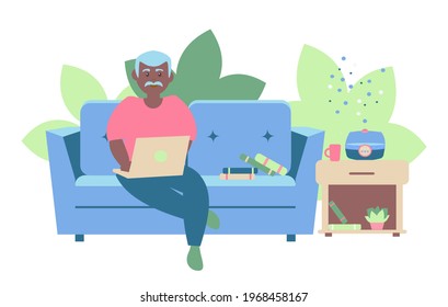 Freelancer working at home Senior african american man seat on sofa with note book and humidifier near nightstand