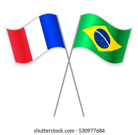 French and Brazilian crossed flags. France combined with Brazil isolated on white. Language learning, international business or travel concept.