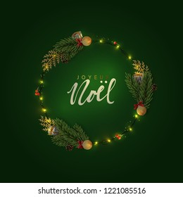 French text Joyeux Noel. Christmas background of circular frame with pine branches and xmas balls. Handwritten text Merry Christmas and Happy New Year. Holiday greeting card, banner, web poster