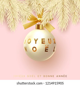 French text Joyeux Noel. Merry Christmas and Happy New Year. Xmas decoration beige golden ball hanging on ribbon with bow. Festive background decor pine branches and round bauble. 