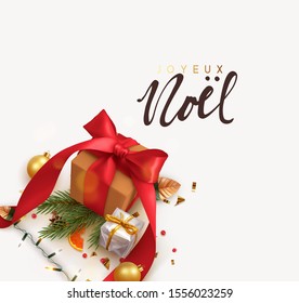 French text Joyeux Noel. Merry Christmas. Background with realistic festive gifts box. Xmas present. brown boxes with red ribbon gift surprise, Golden Christmas baubles, balls, glitter gold confetti.