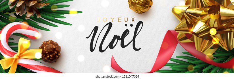 French text Joyeux Noel. Translation: (Merry Christmas)  Xmas festive decoration. Horizontal banner, christmas posters, cards, headers, website. Sparkling lights garland with gifts bow and green pine 