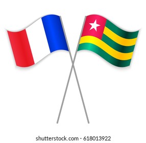 French and Togolese crossed flags. France combined with Togo isolated on white. Language learning, international business or travel concept.