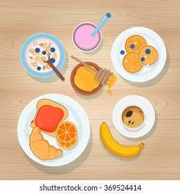 Fresh breakfast with coffee, fruits and sweet pastries on wooden background. Top view