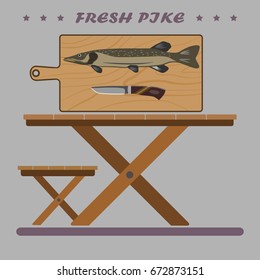 Fresh and delicious fish for your holiday. A big pike and a knife on the board. From below a folding table and a chair.