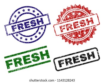 FRESH seal stamps with damaged surface. Black, green,red,blue vector rubber prints of FRESH text with scratched surface. Rubber seals with circle, rectangle, medal shapes.
