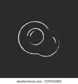Fried egg hand drawn in chalk on a blackboard vector white icon isolated on a black background.