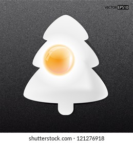 Fried egg like xmas tree on frying pan.