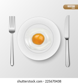 fried egg in white plate with fork and knife