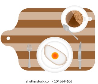fried eggs for breakfast on plate, with fork and knife on the wooden cooked desk. Top view