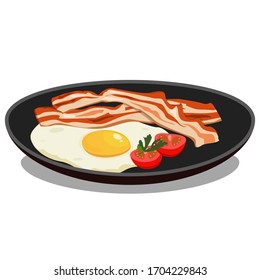 Fried eggs on a black stylish fashion plate, with fresh tomatoes and herbs and fried bacon, isolated on a white background