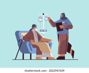 friendly arab nurse or volunteer checking dripper of elderly man patient home care services healthcare