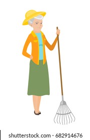 Friendly female caucasian farmer standing with gardening rake. Full length of senior smiling farmer holding a gardening rake. Vector flat design illustration isolated on white background.